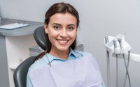 Woman sitting in dental chair smiling