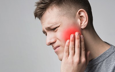 Man with jaw pain needing TMJ treatment in Wayland, MA