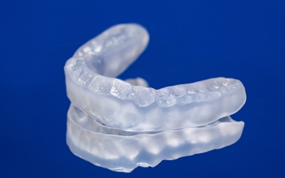 Close up of occlusal splint on a blue background